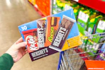 hand holding a box of hersheys full size candy bars