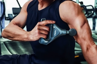 Lifestyle image of FitRx VibraBand Back Massager: Man using this tool on his upper arm