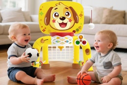 Toddler playing with a basketball.