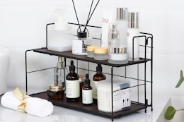 7.3"D x 16"W x 9.8"H two-tier organizer for bathroom or kitchen counter. Metal frame with wood shelves. Non-slip feet.