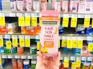 hand holding nature's bounty  hair skin and nails gummies