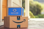 an amazon and sams club shipping box sitting on a front porch