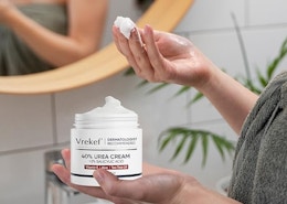 a person holding a jar of urea cream 