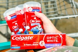 hand holding old spice deodorant colgate toothpaste