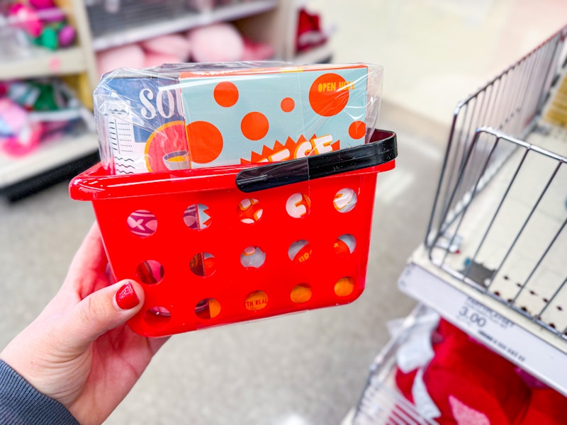 hand holding a red Food Basket Toy Set