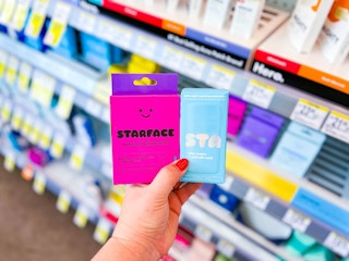 hand holding star face moisturizer and patches