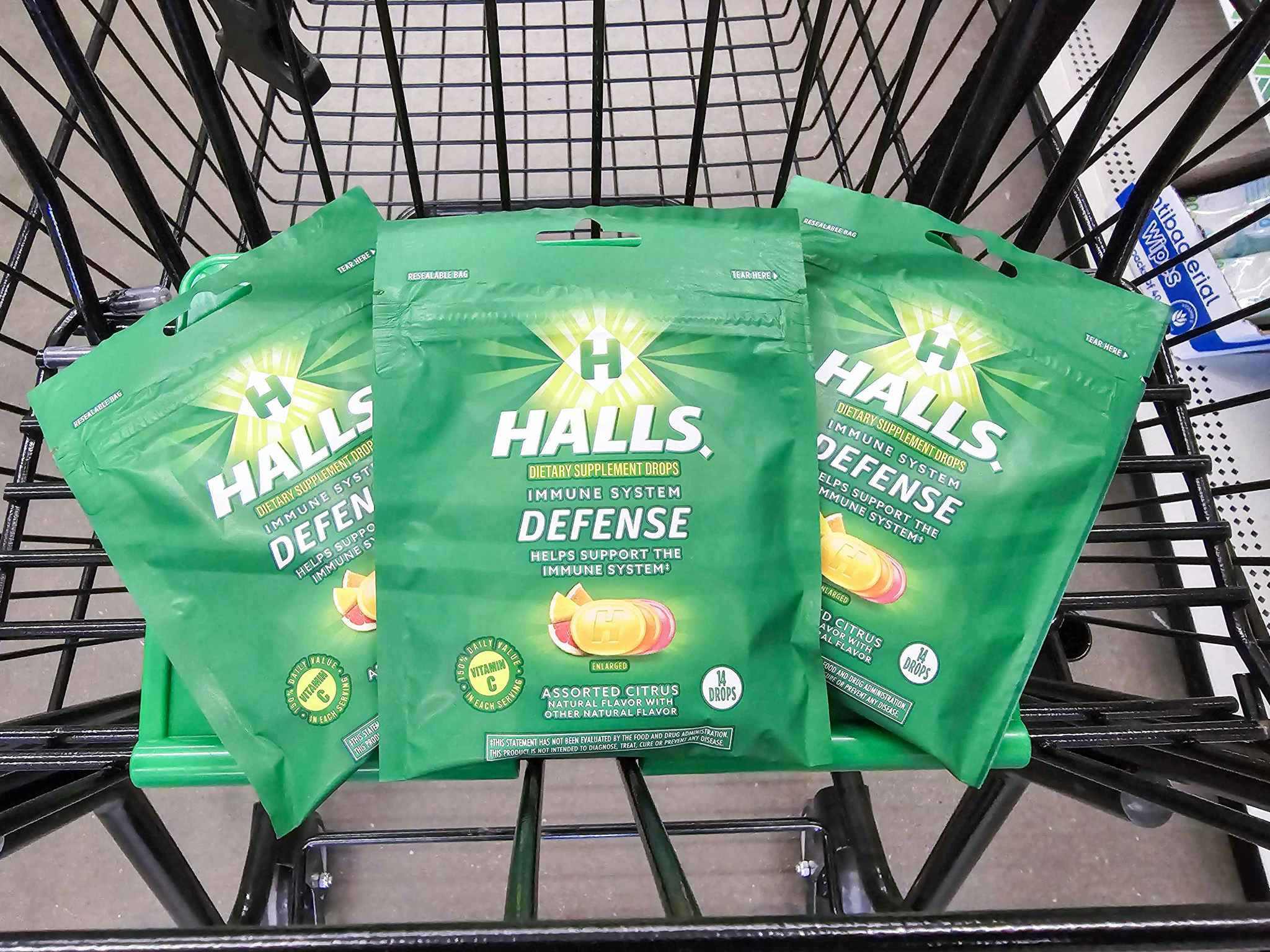 3 bags of halls cough drops in a cart