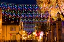 FLVOECN LED Christmas Lights hanging from store fronts.
