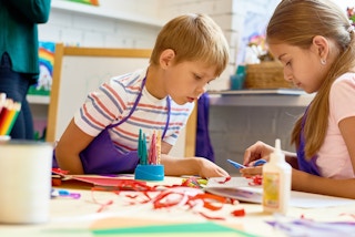 boy girl art class students smocks supplies