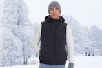 Man wearing the Rrtizan Heated Vest outdoors in the snow.