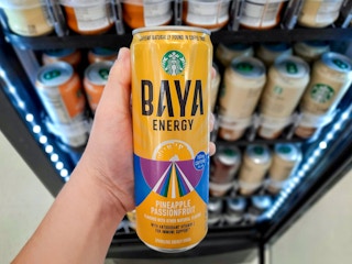 Starbucks Baya Energy held in front of drink cooler at Walmart