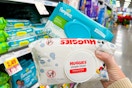 hand holding packs of huggies wipes pampers wipes