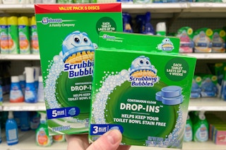 hand holding scrubbing bubbles toilet tablets
