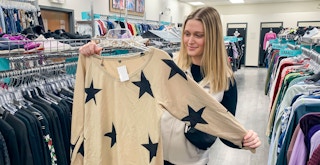 person holding shirt plato's closet