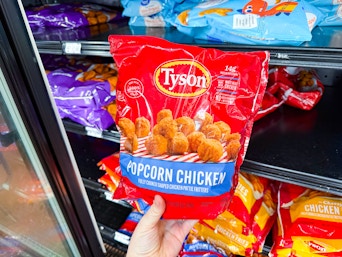 Tyson Popcorn Chicken being pulled from freezer section at Walmart