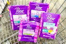 4 packs of poise pads in a cart