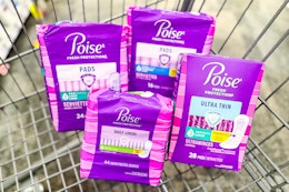 4 packs of poise pads in a cart