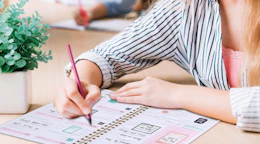 a person writing in a planner 