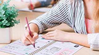 a person writing in a planner