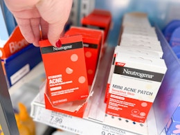 hand grabbing neutrogena stubborn acne patches off a target shelf