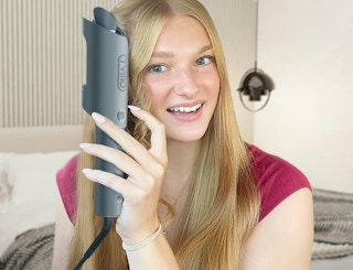 a women curling her hair 