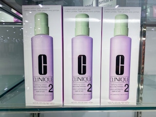 three purple bottles of clinique skincare