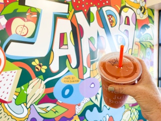 woman holding smoothie