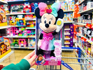 hand holding the Minnie Mouse Sparkle and Sing plush