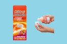 Two disembodied hands pour a dose of children's Motrin next to a box of children's Motrin.