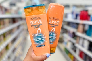 hand holding two bottles of L'Oreal Elvive shampoo & conditioner