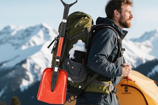 a man carrying a snow shovel
