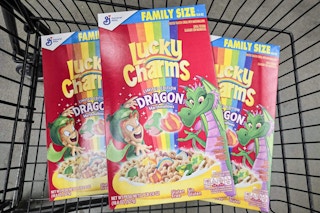 3 boxes of lucky charms cereal in a cart