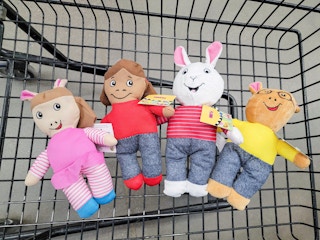 arthur character plushes in a cart