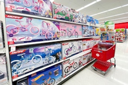 kids' bikes sitting on a shelf with a target cart parked in front