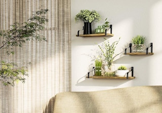 Three floating shelves above a couch.