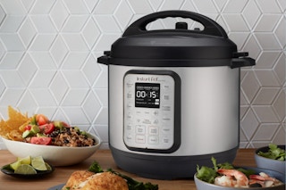 a pressure cooker on a table with food