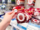hand grabbing a febreze small spaces air freshener off a target shelf
