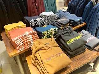carhartt sweatshirts folded on a table in the store