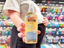 Palmer's Baby Oil held up in front of person in Walmart store