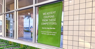 A sign inside of a Publix store listing the competitor stores from which Publix will accept coupons.