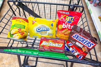old el paso, snickers, ritz, oreo, hot tamales in a dollar tree shopping cart