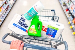 walgreens napkins, laundry detergent, toilet paper, and disinfecting wipes in a cart