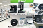 roomba vacuums sitting on a target shelf