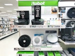 roomba vacuums mops sitting on a target shelf