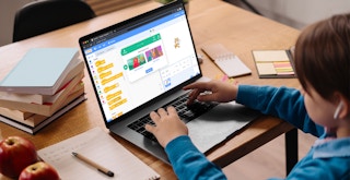 A child learning code on the Scratch website