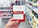 hand holding l'oreal revitalift moisturizer in walgreens