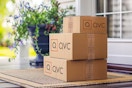 a stack of qvc boxes on a porch