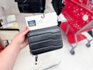 hand holding an open story hardside dopp kit case at target