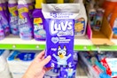 hand holding a trial size pack of luvs diapers