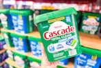 hand holding up a pack of cascade dishwasher pacs